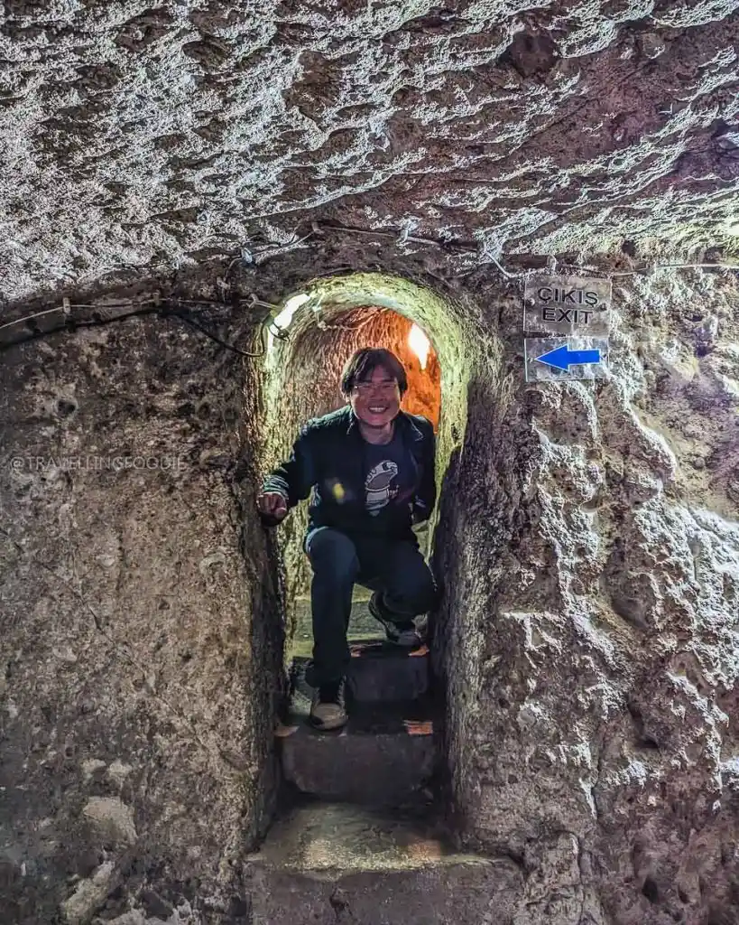 Travelling Foodie Raymond Cua crawling through the narrow exit tunnel at Derinkuyu Underground City, challenging for claustrophobia