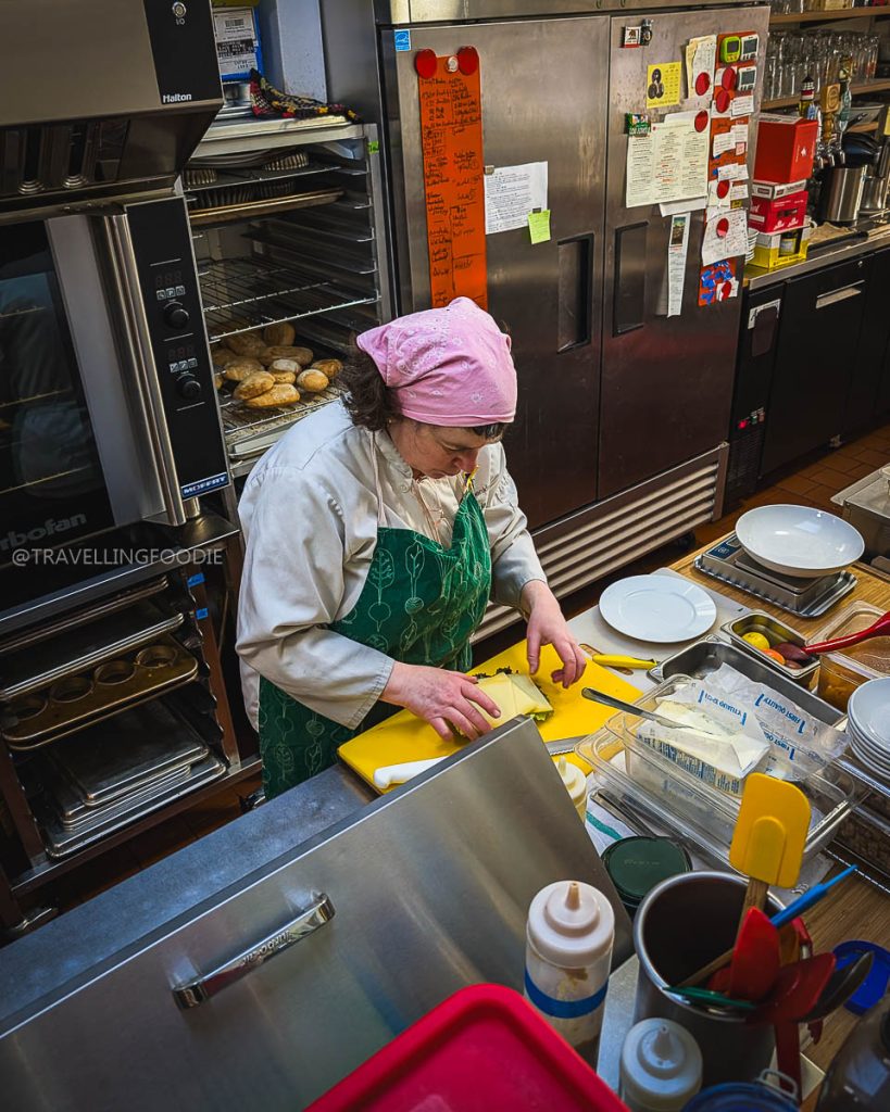 Chef Anja Voth preparing an authentic German breakfast at Anja's Kitchen, a top place to eat in Berkeley.