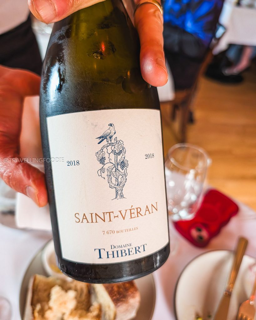A bottle of 2018 Domaine Thibert Saint-V&eacute;ran wine, perfectly paired with seasonal Berkeley food at Chez Panisse.