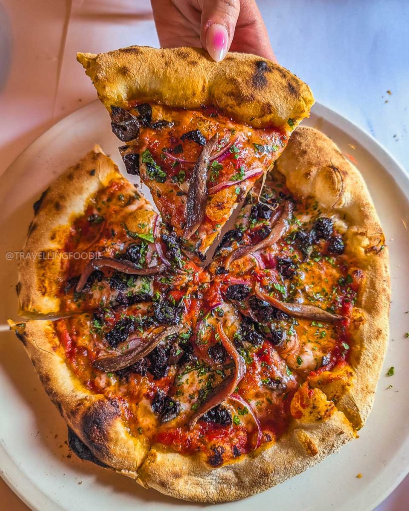 Wood-fired anchovy pizza at Chez Panisse, highlighting the legendary farm to table Berkeley food scene.