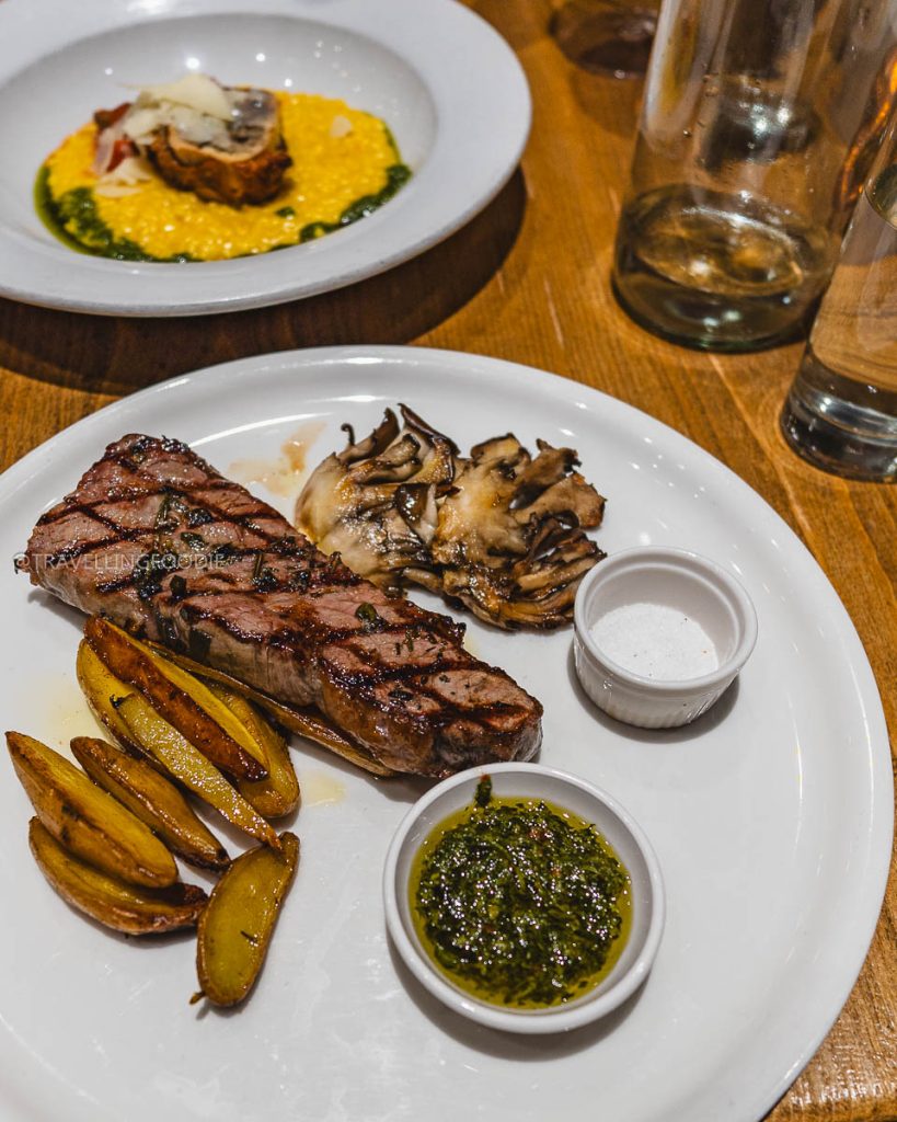 Dry-aged steak and saffron risotto at Donato and Co, showcasing exactly where to eat in Berkeley for dinner.