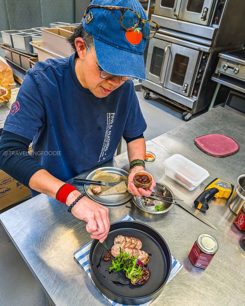 Chef Jin plating duck roulade at Fins & Feathers, a unique specialty food and drink experience in Berkeley.