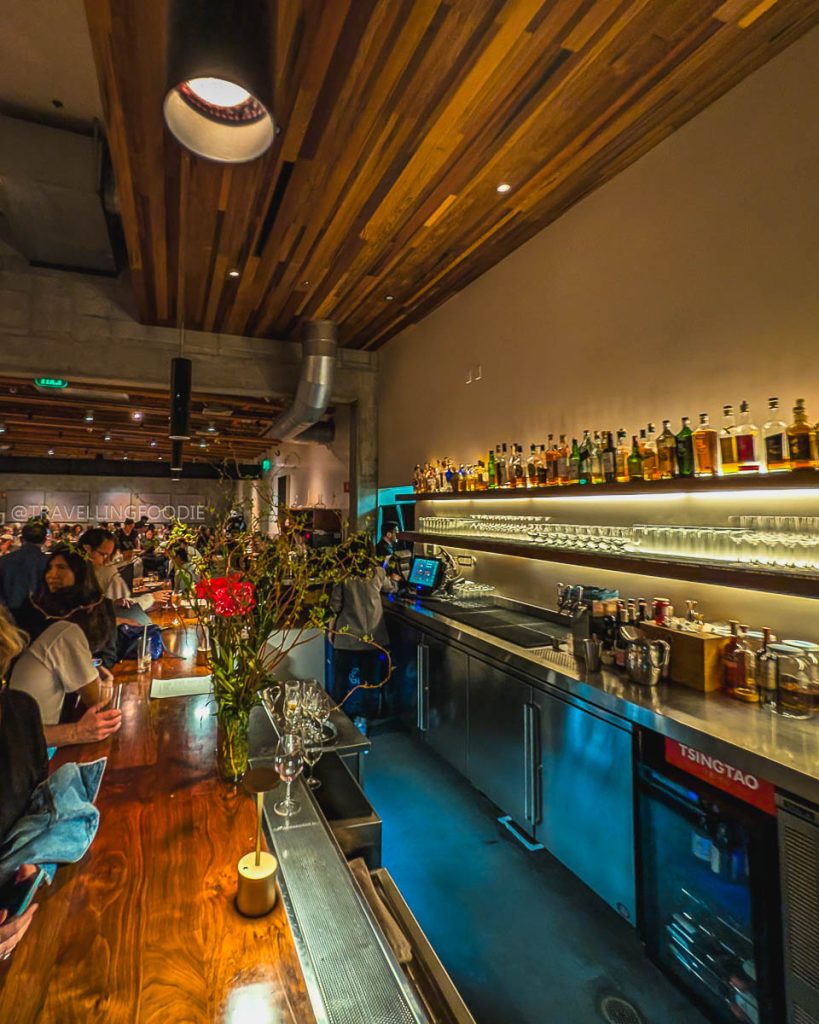 The sleek wooden bar at Great China, a Michelin recognized spot for specialty food and drinks in Berkeley.