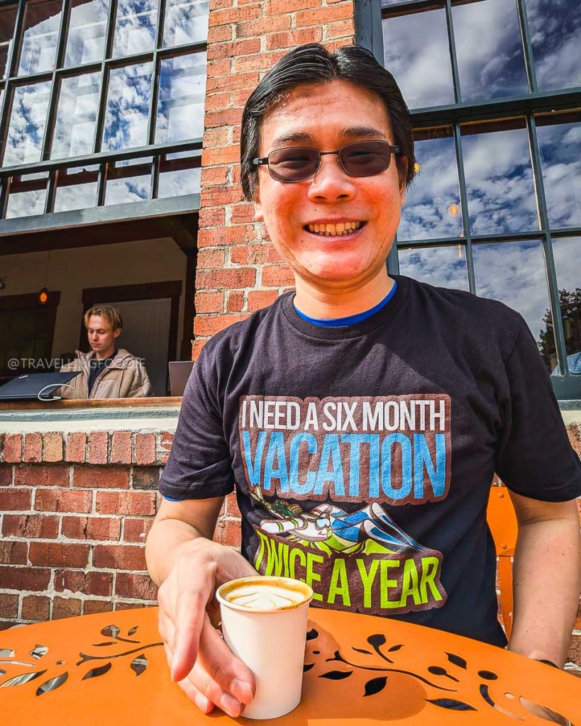 Travelling Foodie Raymond Cua enjoying a morning coffee at The Hidden Cafe in Strawberry Creek Park, exploring the best places to eat in Berkeley.