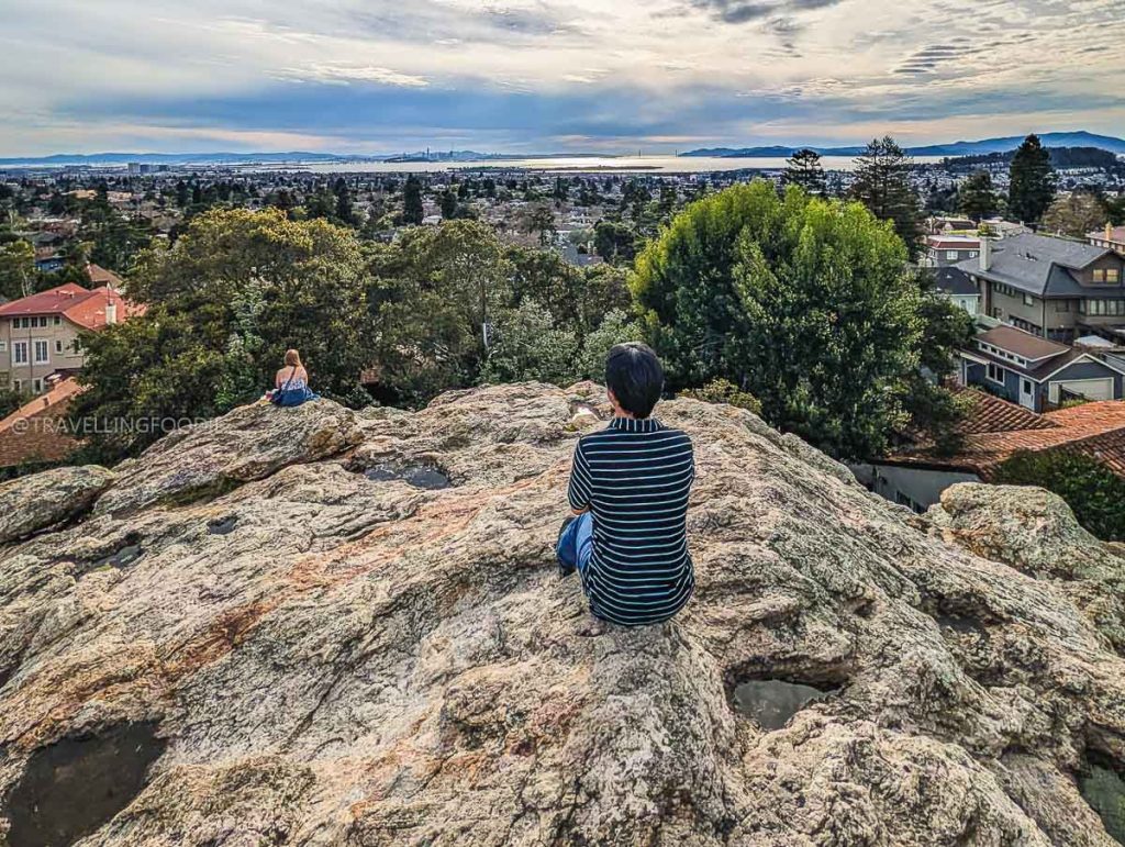 Travelling Foodie Raymond Cua relaxing at Indian Rock Park overlooking the San Francisco Bay, a must-visit spot when exploring things to do in Berkeley.