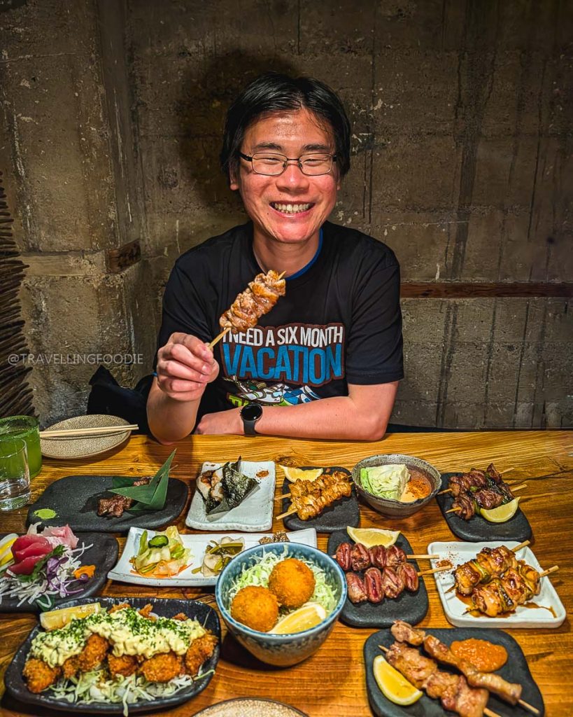 Travelling Foodie Raymond Cua enjoying a massive feast of authentic yakitori skewers at Ippuku, one of the absolute best restaurants in Berkeley.