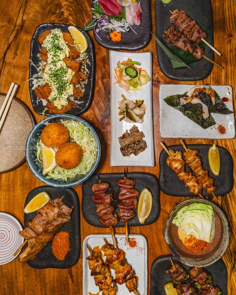 Top-down view of yakitori and sashimi at Ippuku, a Michelin-recognized spot and one of the best restaurants in Berkeley.