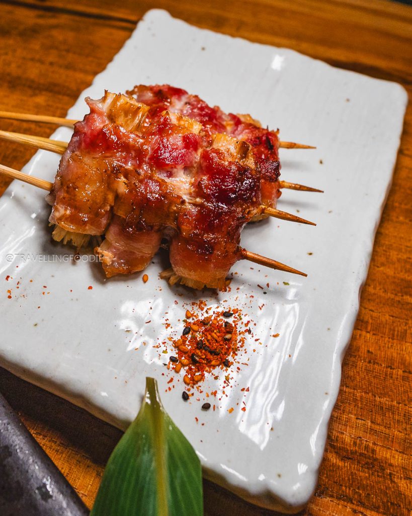 Savory Enoki Bekon bacon-wrapped skewers at Ippuku, highlighting incredible specialty food and drinks in Berkeley.
