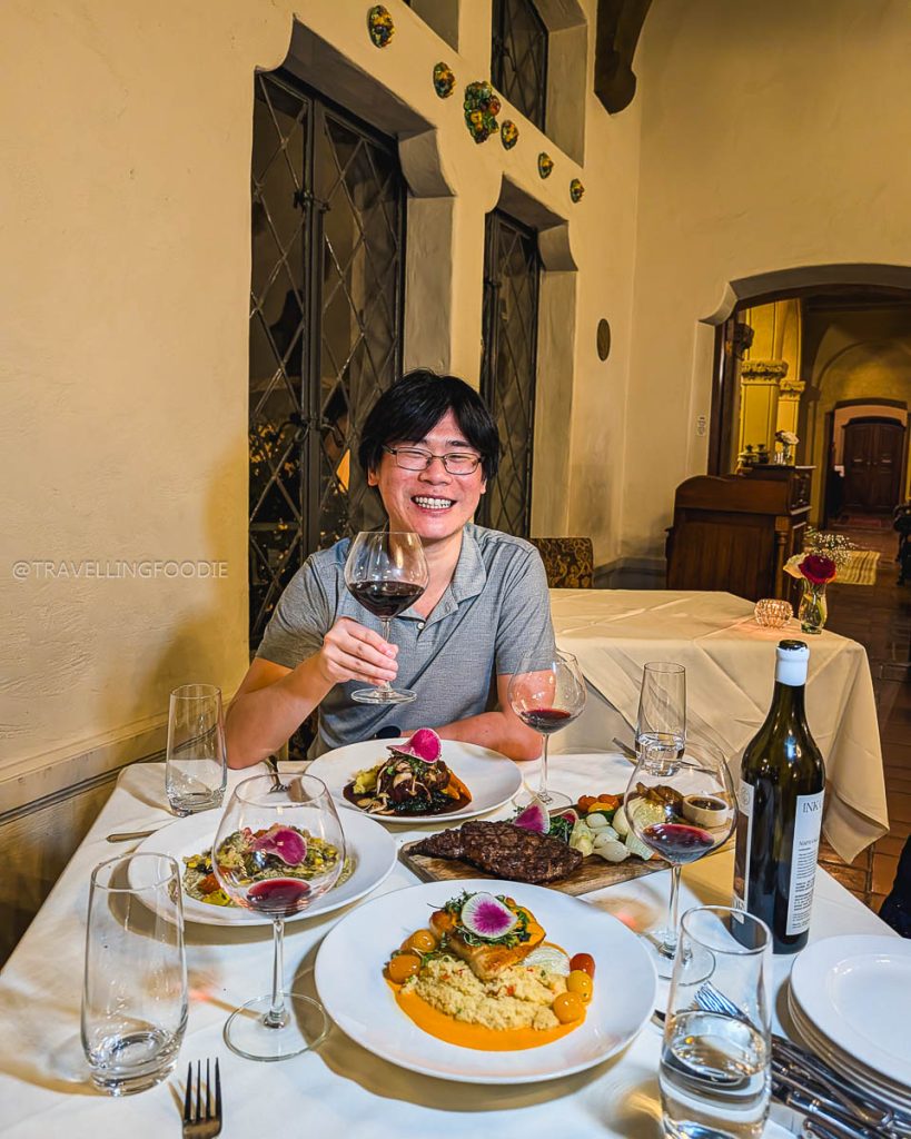 Travelling Foodie Raymond Cua enjoying wine and a fine dining feast of steak and halibut at Julia's Restaurant, a top place to eat in Berkeley.