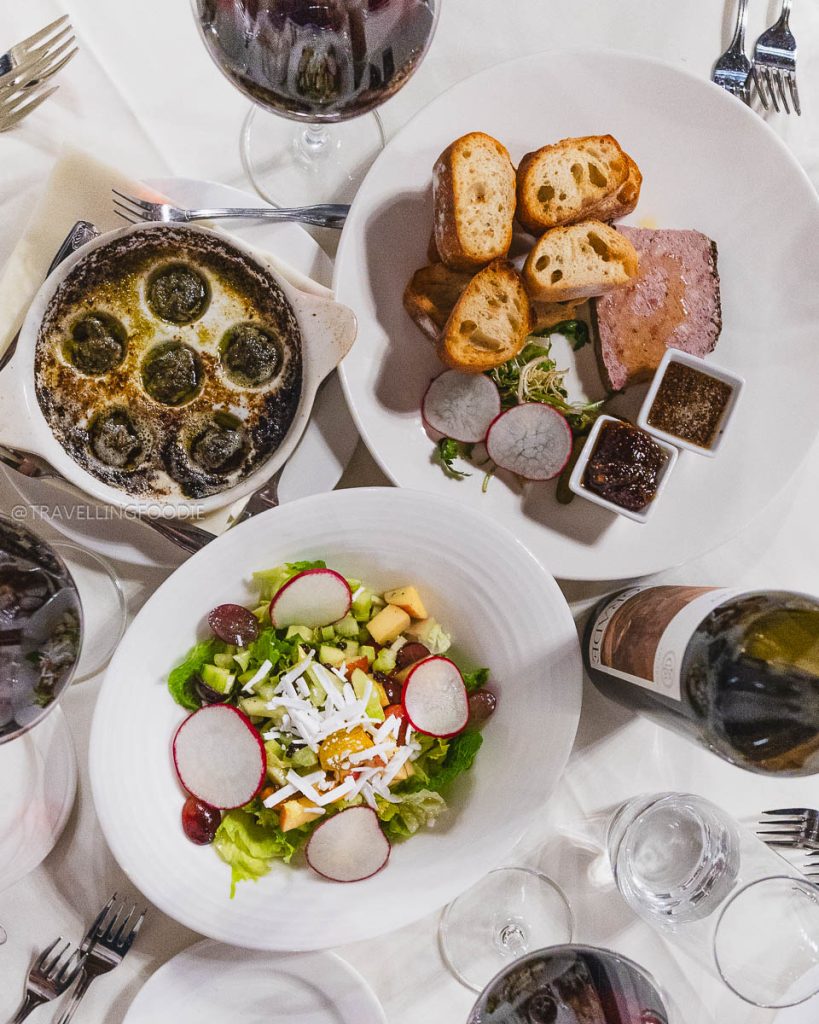 Elegant appetizers of baked escargot, pate, and fresh salad at Julia's Restaurant, a beautiful place to eat in Berkeley.