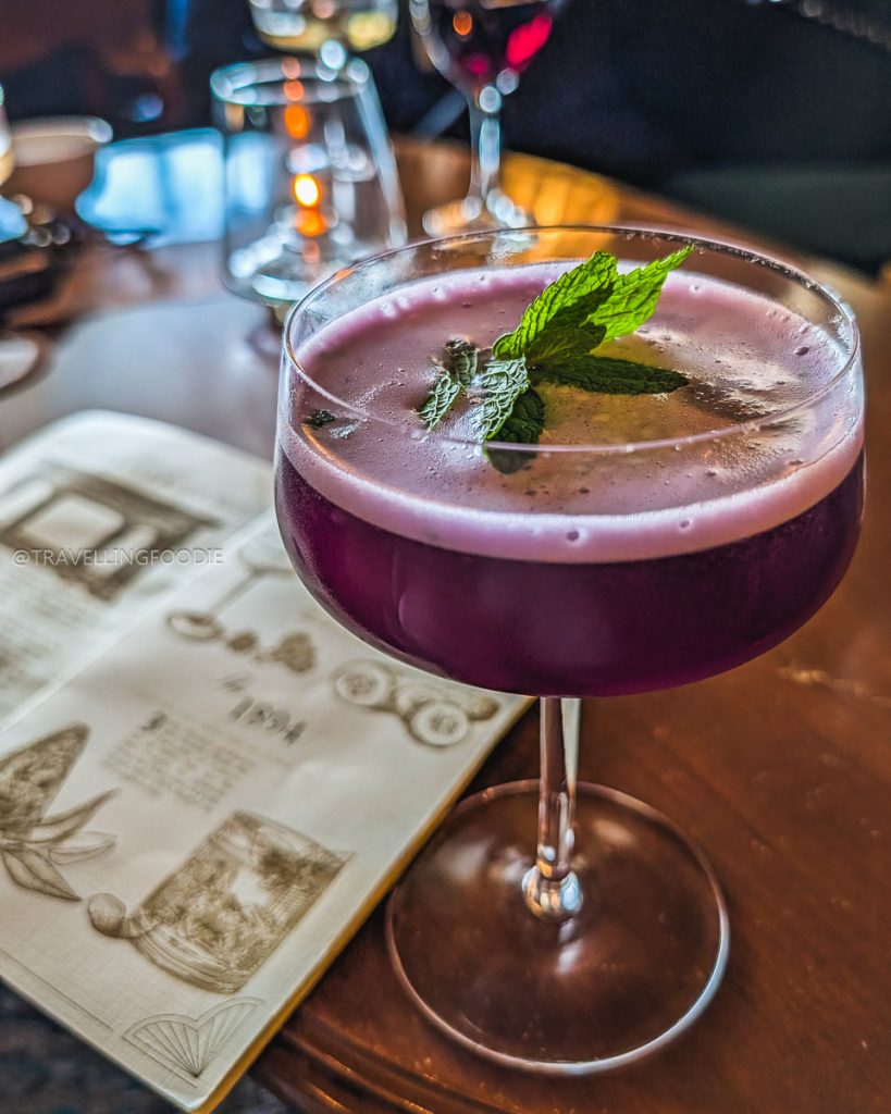 The Little Castle butterfly pea cocktail at Morgan's Bar, a historic 1880s lounge in the vibrant Berkeley drink scene.