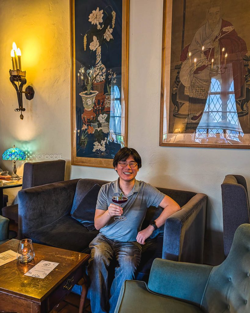 Travelling Foodie Raymond Cua relaxing with a craft cocktail at Morgan's Bar in the historic Berkeley City Club, exploring the Berkeley food scene.