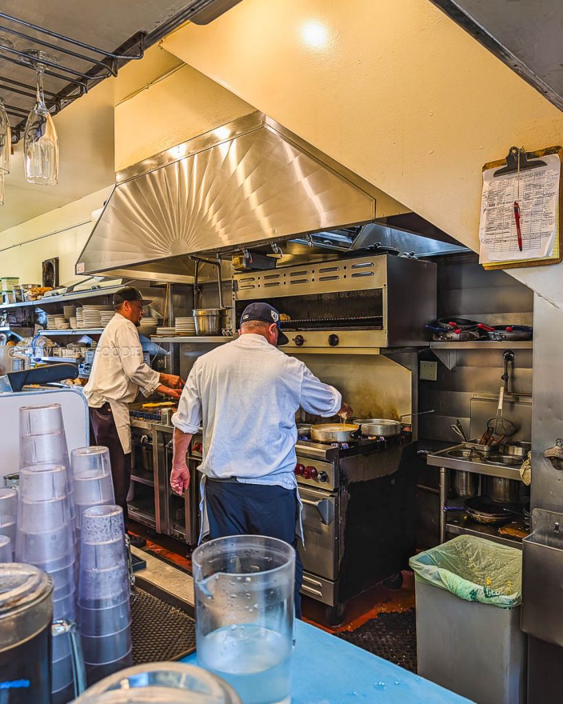 Chefs cooking at the grill inside Oceanview Diner, a legendary 1982 destination for the best breakfast in Berkeley.