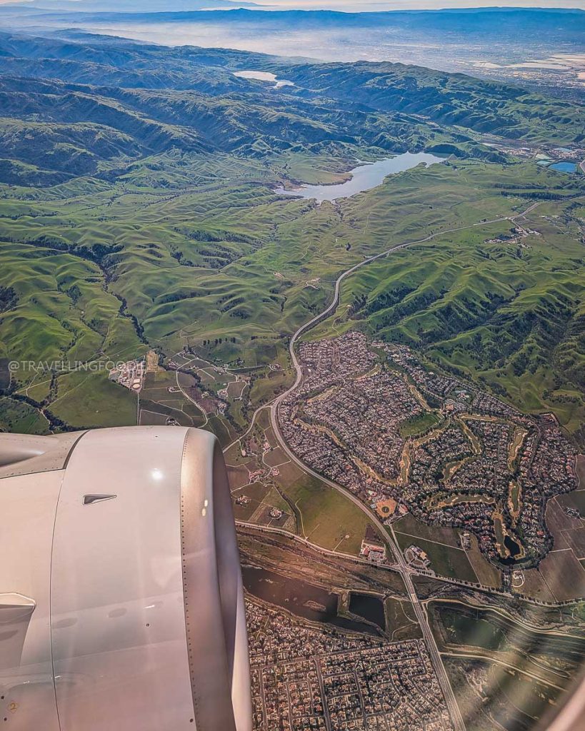 Aerial view of the Bay Area during a flight, arriving to explore the amazing Berkeley food scene and top restaurants.