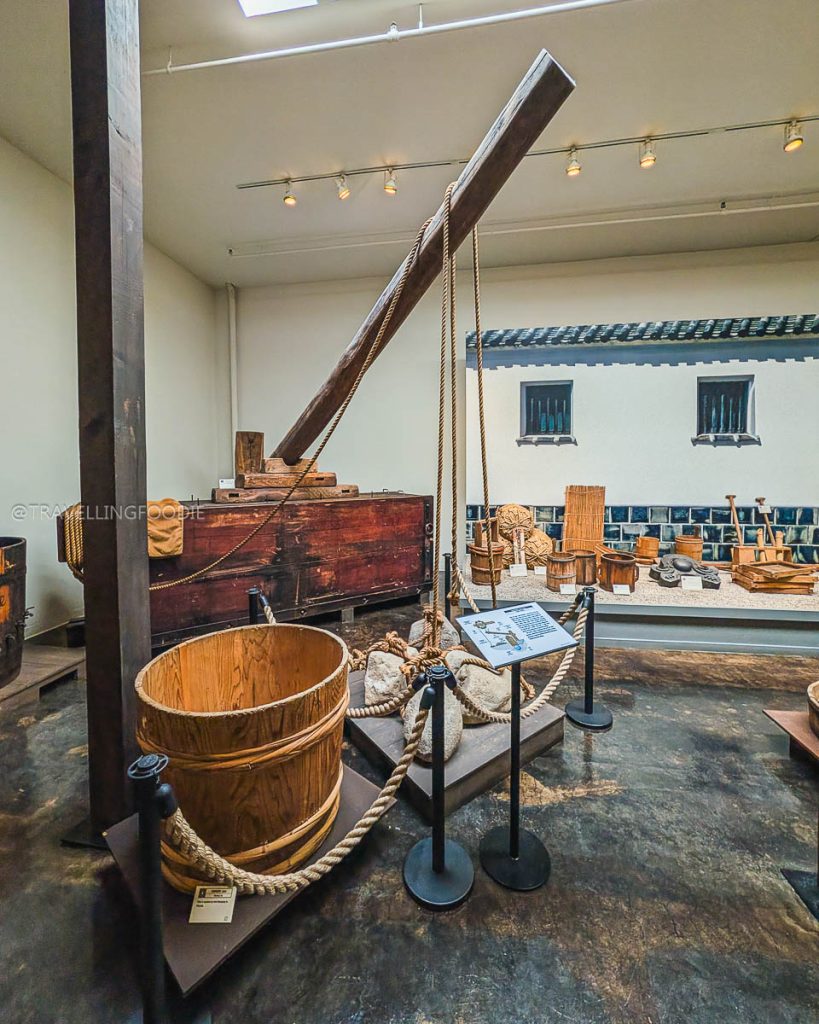 A traditional wooden sake press on display at the Takara Sake Museum, showcasing Berkeley's diverse culinary history.