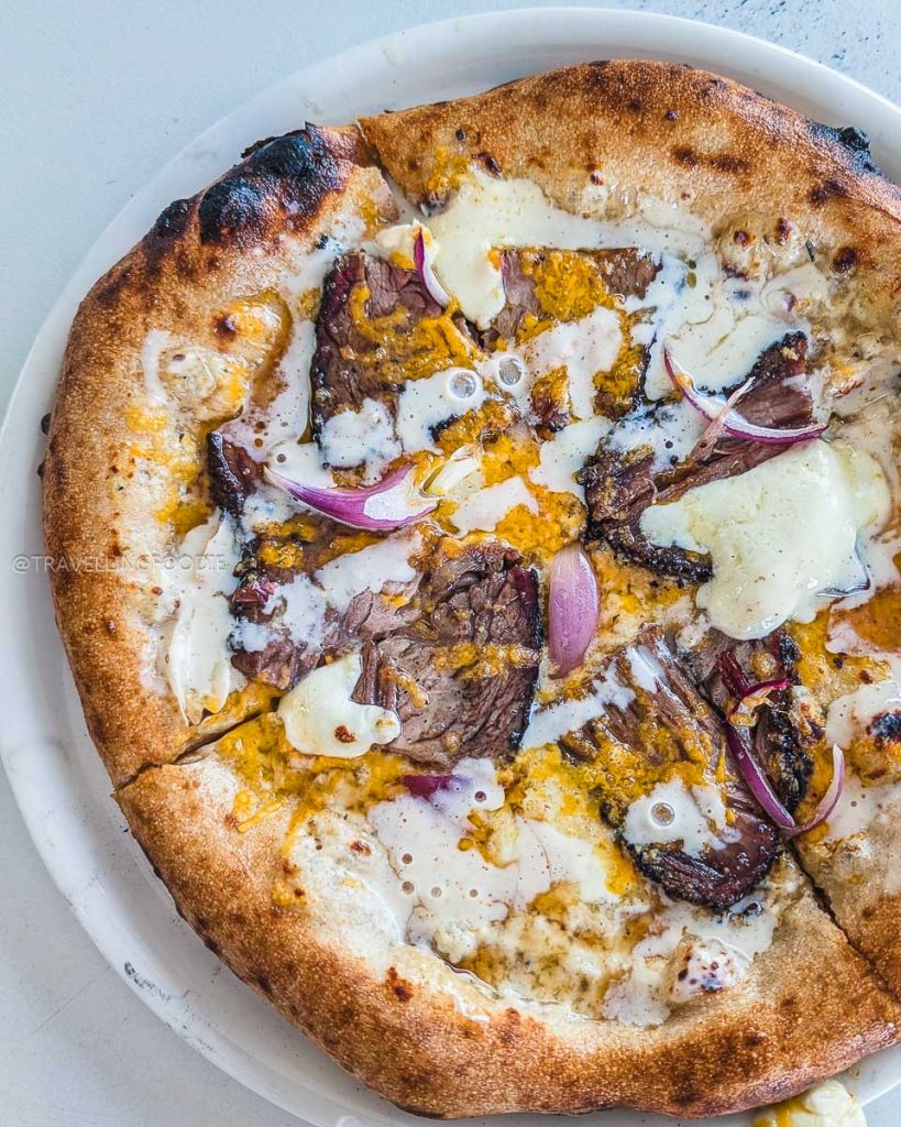 The Cowboy Beef Brisket Pizza with horseradish cream at Alibi, a famous dish when deciding what to eat in Laramie.