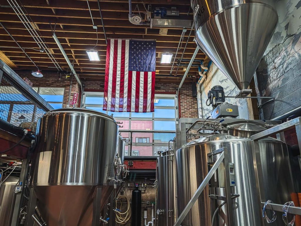Stainless steel brewing tanks inside Bond's Brewing Company, showcasing the best places to drink in Laramie.