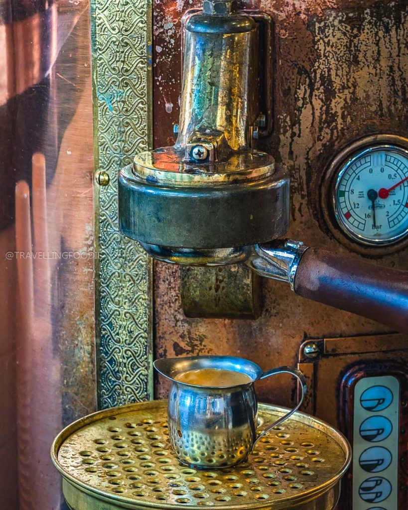 Close up of a vintage copper espresso machine brewing fresh coffee, highlighting the vibrant Laramie cafes scene.