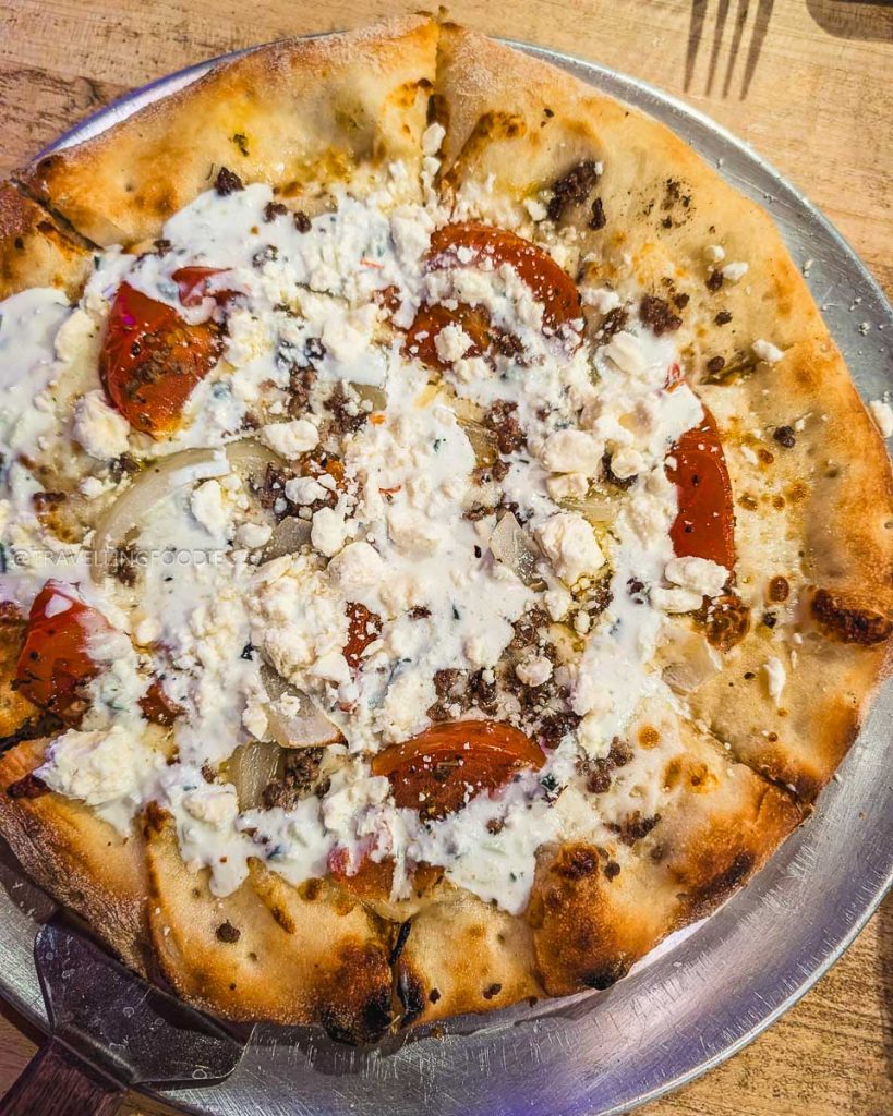 The unique Billhook Pizza with ground lamb and feta at The Crowbar and Grille, highlighting creative Laramie food.