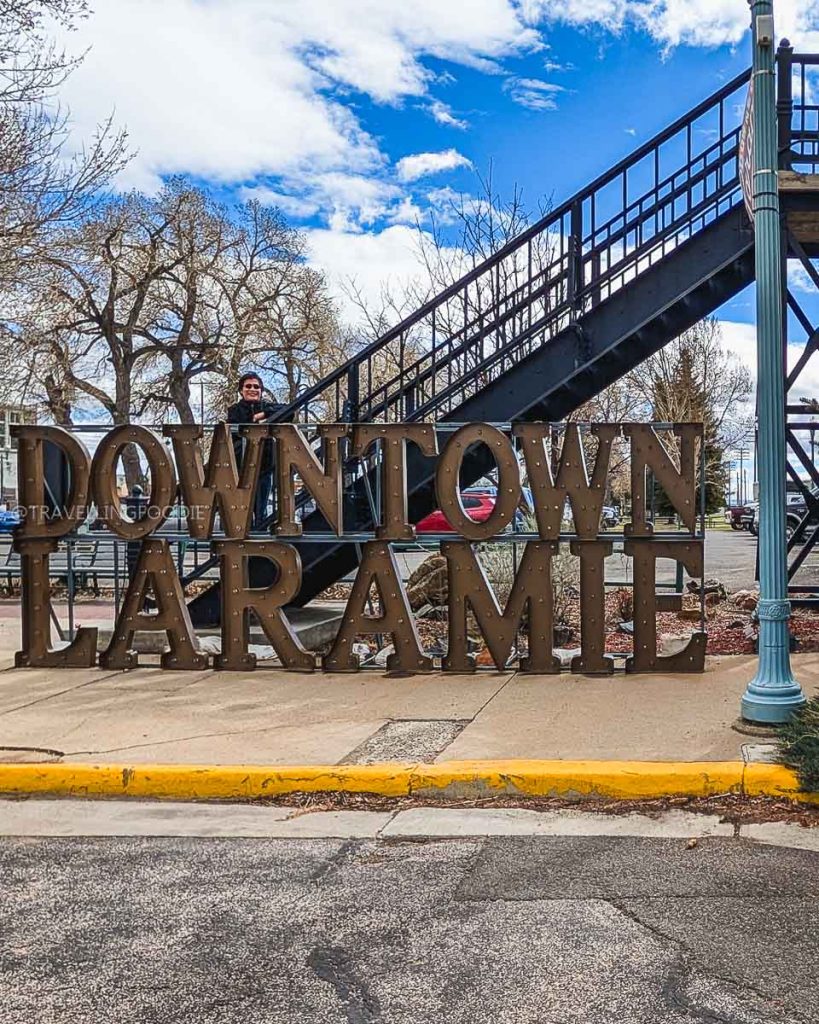 Exploring historic downtown near the pedestrian overpass, surrounded by the best bars in Laramie and local eateries.