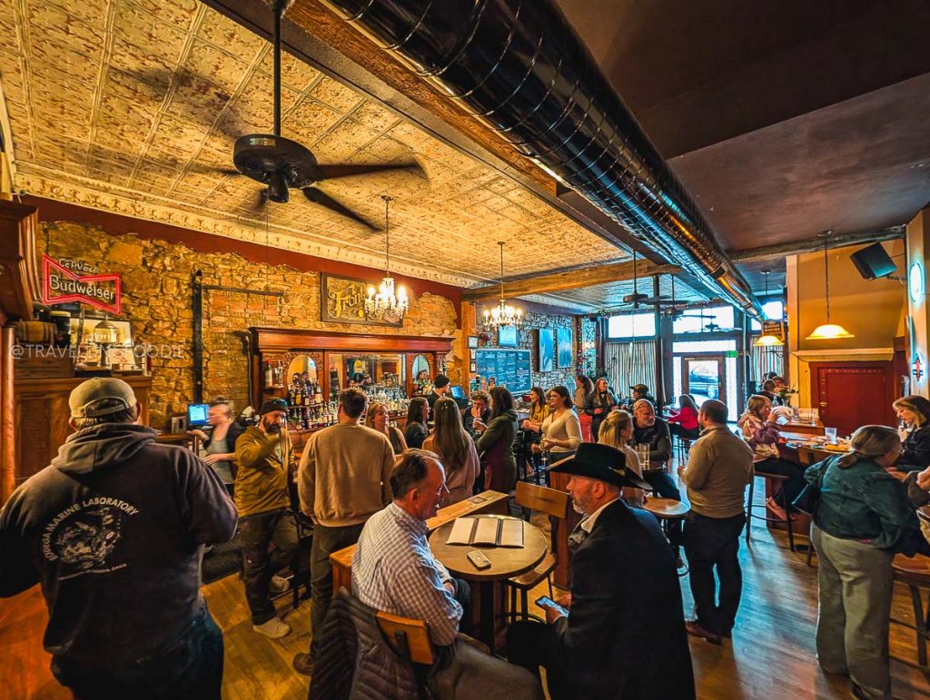 A bustling crowd inside Front Street Tavern, a historic and popular spot among the best bars in Laramie Wyoming.