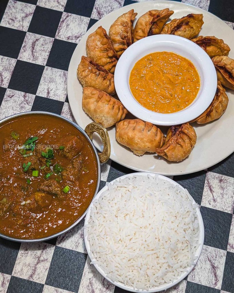 Fried chicken momos and bison curry at Momo House highlighting diverse Laramie food scene options.