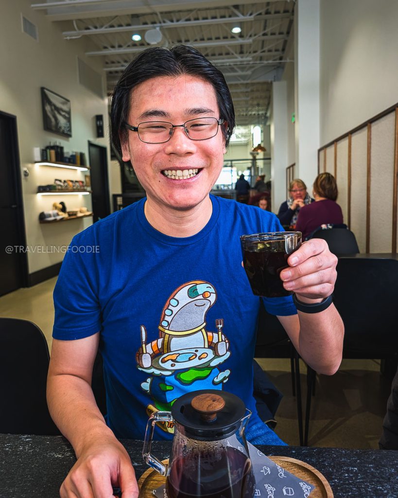 Travelling Foodie enjoying Colombian coffee at Range Coffee Roasters while exploring Laramie cafes.
