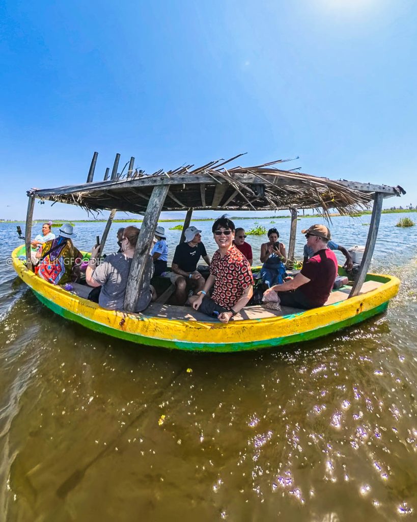 Travelling Foodie Raymond Cua on a traditional thatched-roof boat touring the scenic Coyuca Lagoon, a top thing to do in Acapulco.