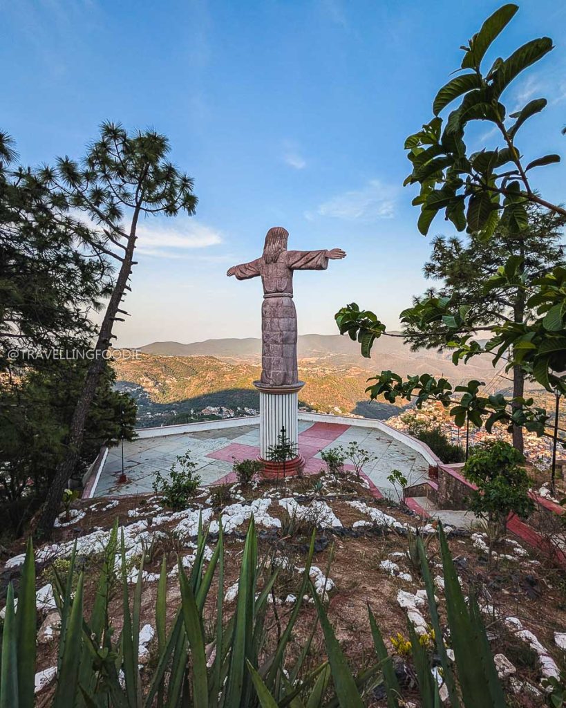 Giant Cristo Monumental statue overlooking the beautiful mountain town of Taxco de Alarcon during a day trip.