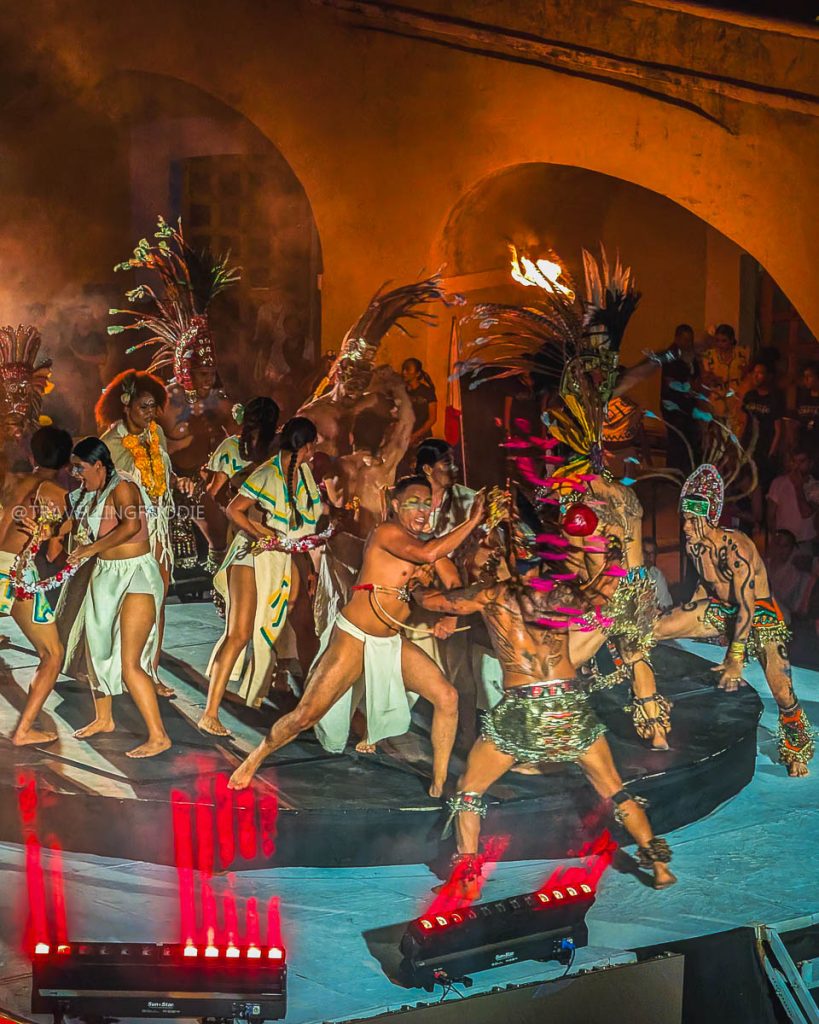 Cultural dancers in indigenous attire performing on stage at the Tianguis Turistico event in Fort San Diego.