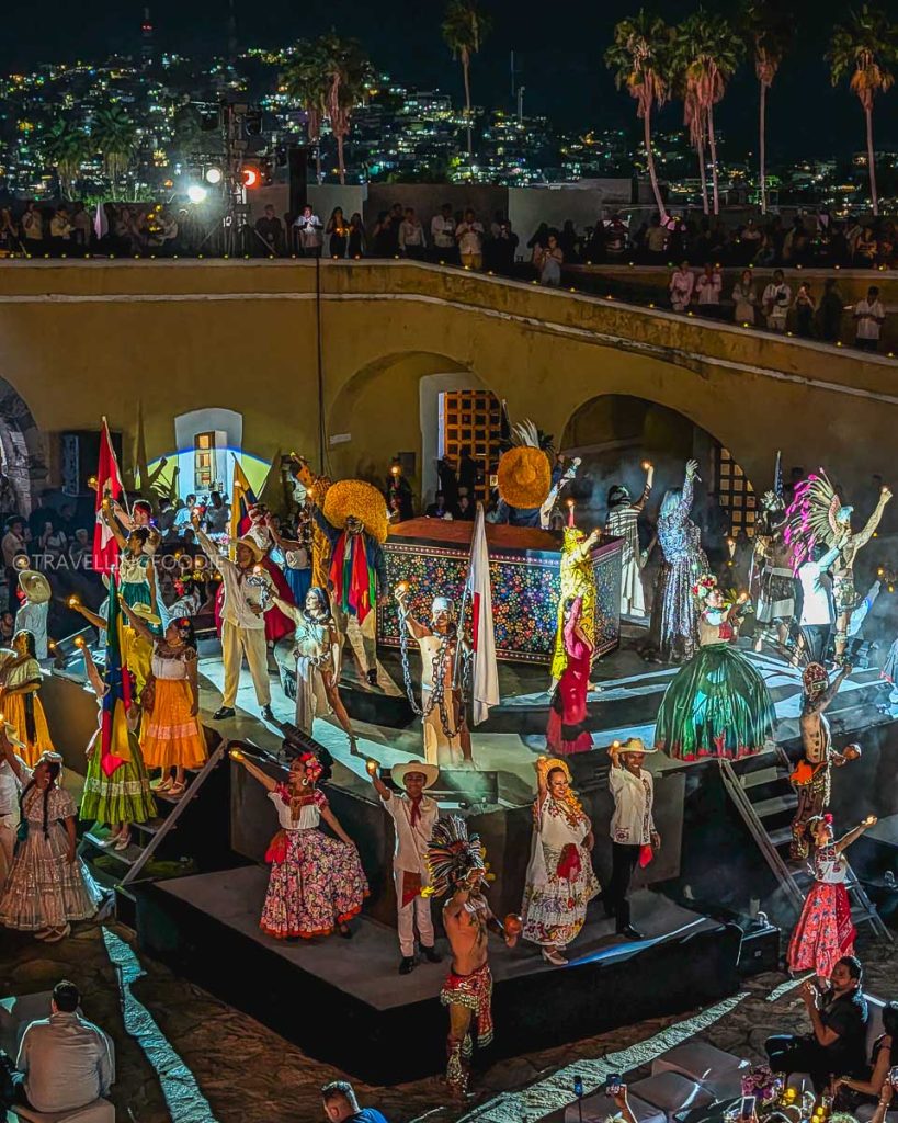 Colorful Mexican cultural performance with traditional costumes and flags at the historic Fort San Diego.