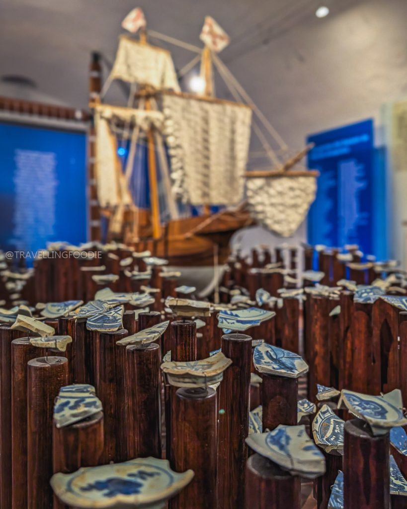Manila Galleon trade exhibit displaying Asian ceramics and a ship model inside the Fort San Diego museum in Acapulco.