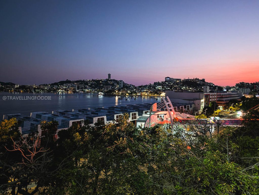 Stunning sunset view of Acapulco Bay and city skyline from a scenic vantage point, a top Acapulco attraction.