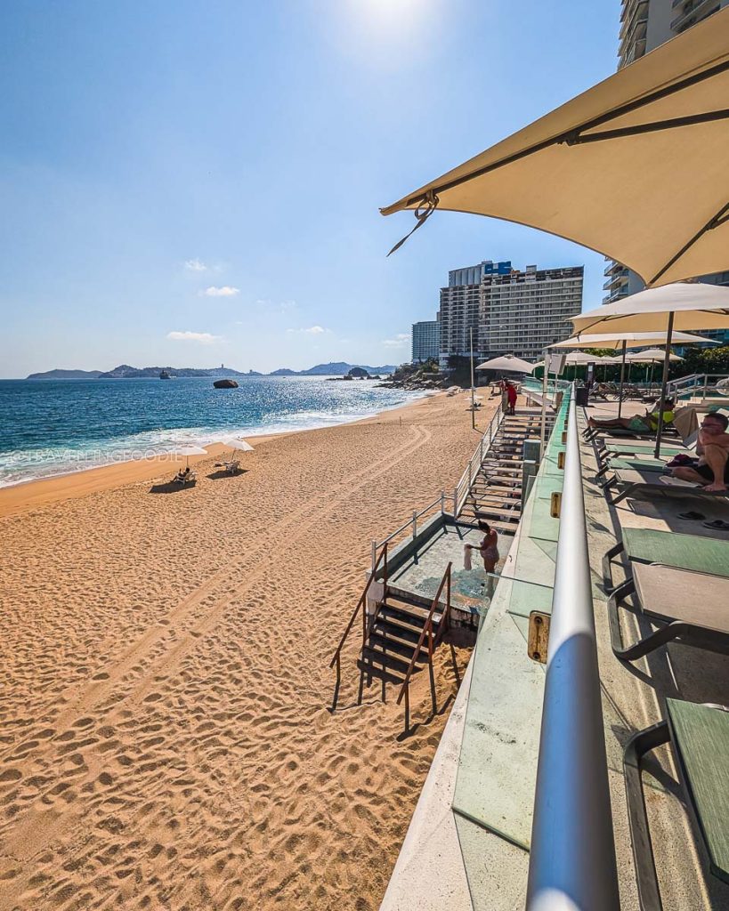 Beautiful sandy shores of Playa Icacos with beach umbrellas and lounge chairs right outside Hotel Amares in Acapulco.