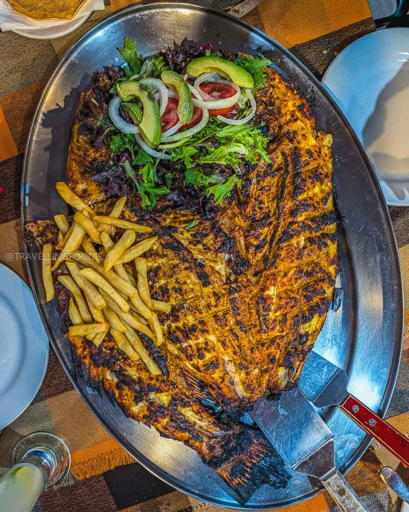 Giant whole grilled huachinango red snapper served with fries, a must try local seafood dish in Acapulco.