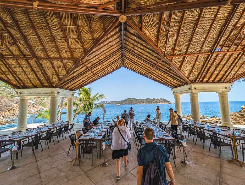 Beautiful thatched roof open-air dining area overlooking the ocean at Punta Sirena restaurant in Acapulco.
