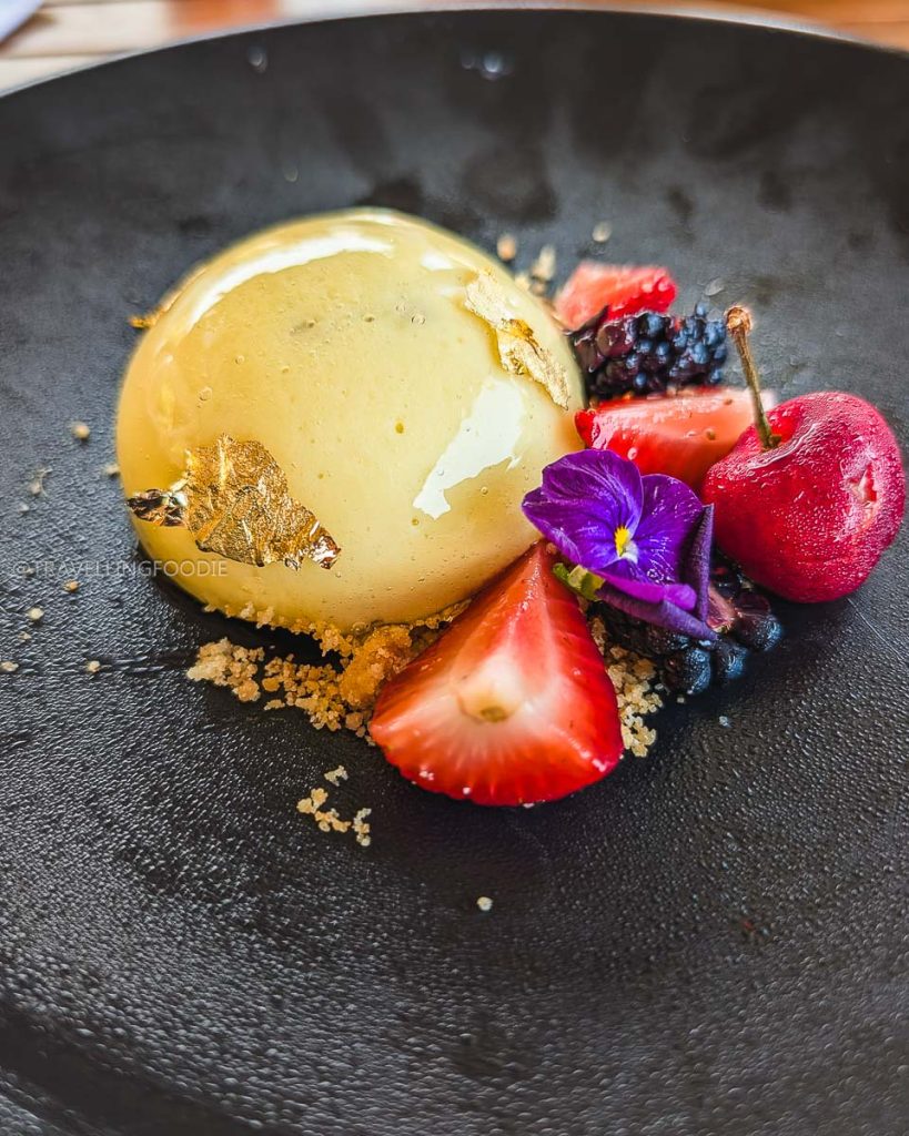 Beautiful gourmet dessert topped with gold leaf and fresh berries, an elevated dining experience at Punta Sirena in Acapulco.