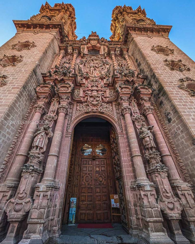 Stunning New Spanish Baroque stone facade of the historic Santa Prisca church, a must-visit in Taxco de Alarcon.