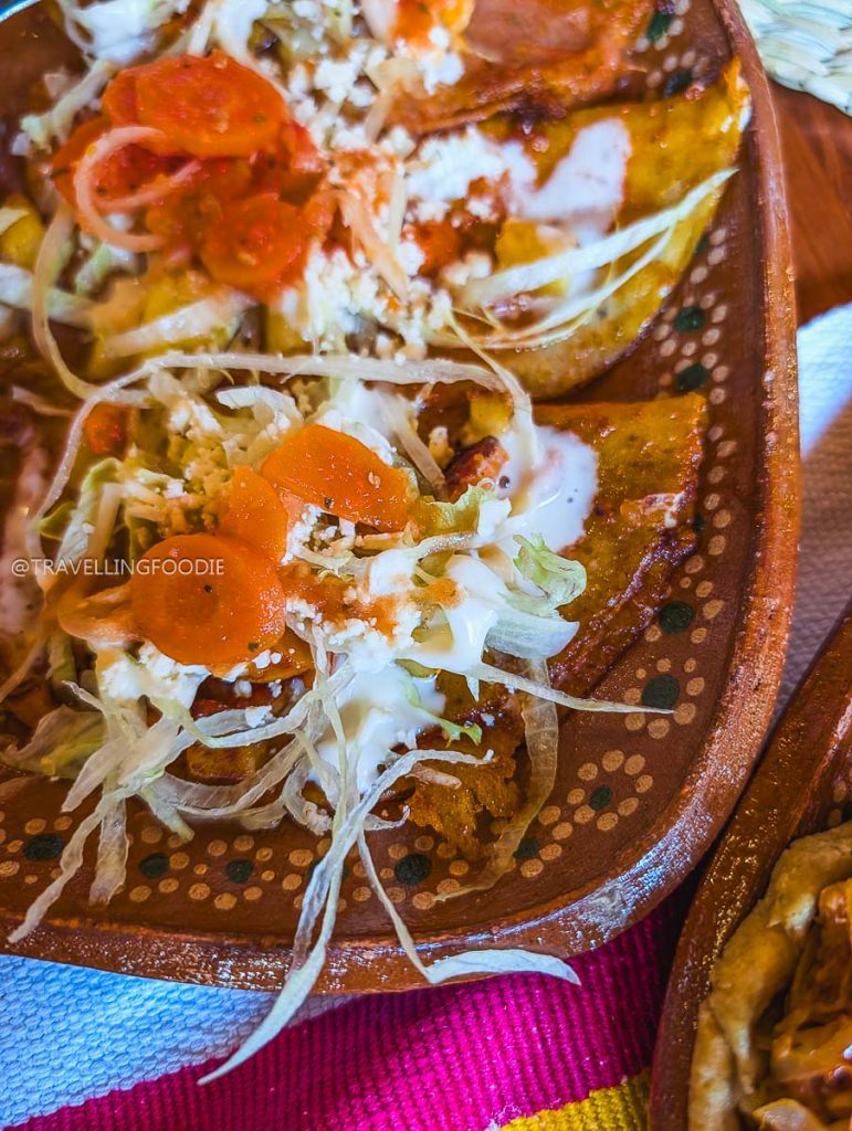 Mouth-watering Enchiladas Placeras topped with fresh vegetables at the best restaurants in Michoacan.