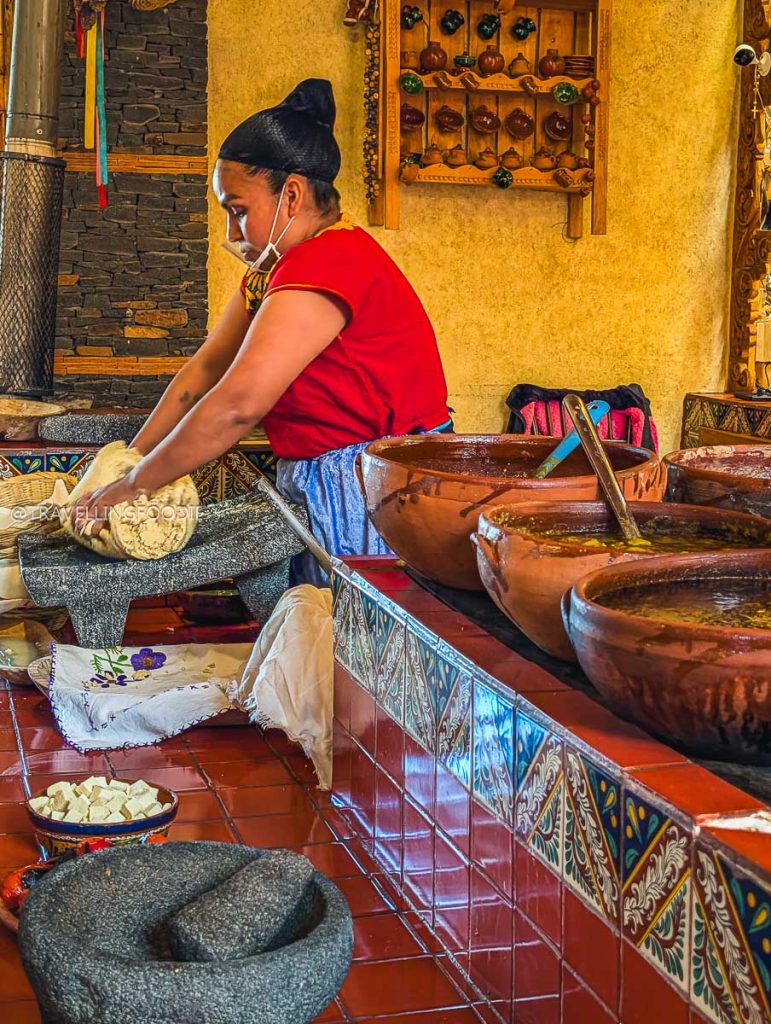 Preparing fresh corn masa on a volcanic metate stone for the best food in Michoacan.