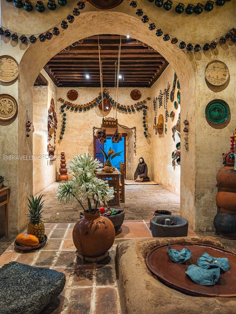 Traditional artisan kitchen exhibit with clay pots and metate to explore on a Mexico vacation.