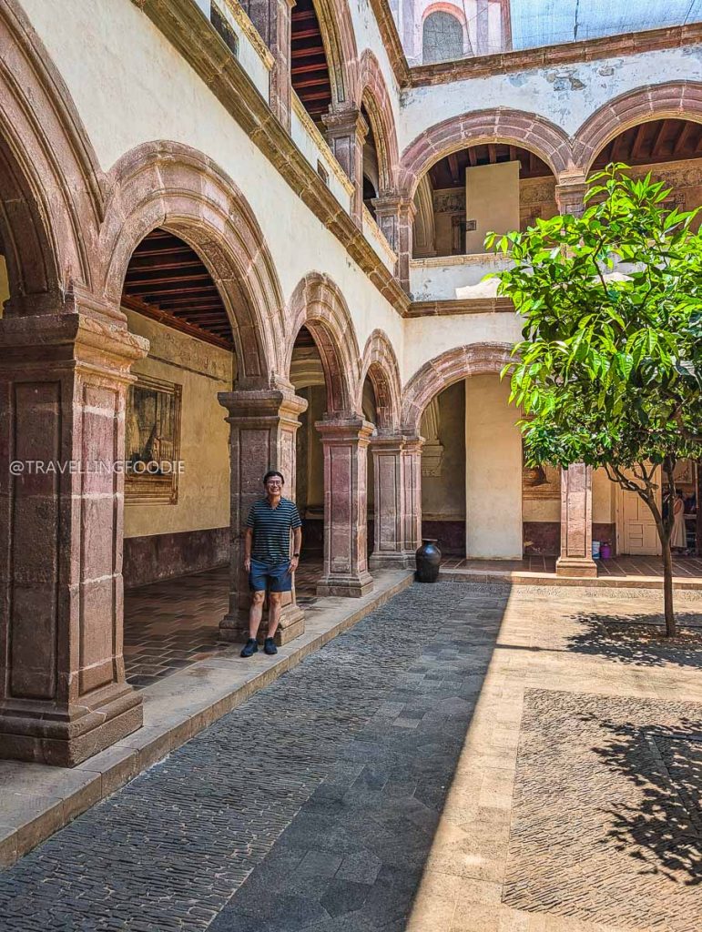 Travelling Foodie Raymond Cua exploring a beautiful pink stone courtyard in Tzintzuntzan during our 3 day trip in Michoacan.