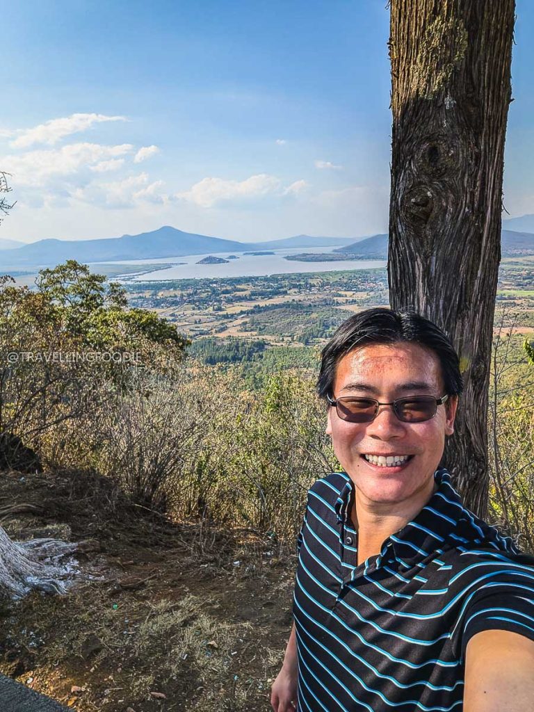 Travelling Foodie Raymond Cua taking a selfie at Estribo Grande viewpoint overlooking Lake Patzcuaro on a Mexico vacation.