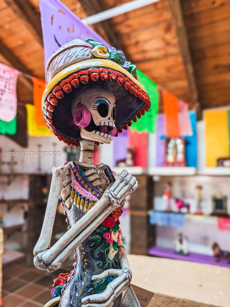 Vibrant hand-painted clay Catrina figure in Capula, a must-see on your 3 days in Michoacan itinerary.