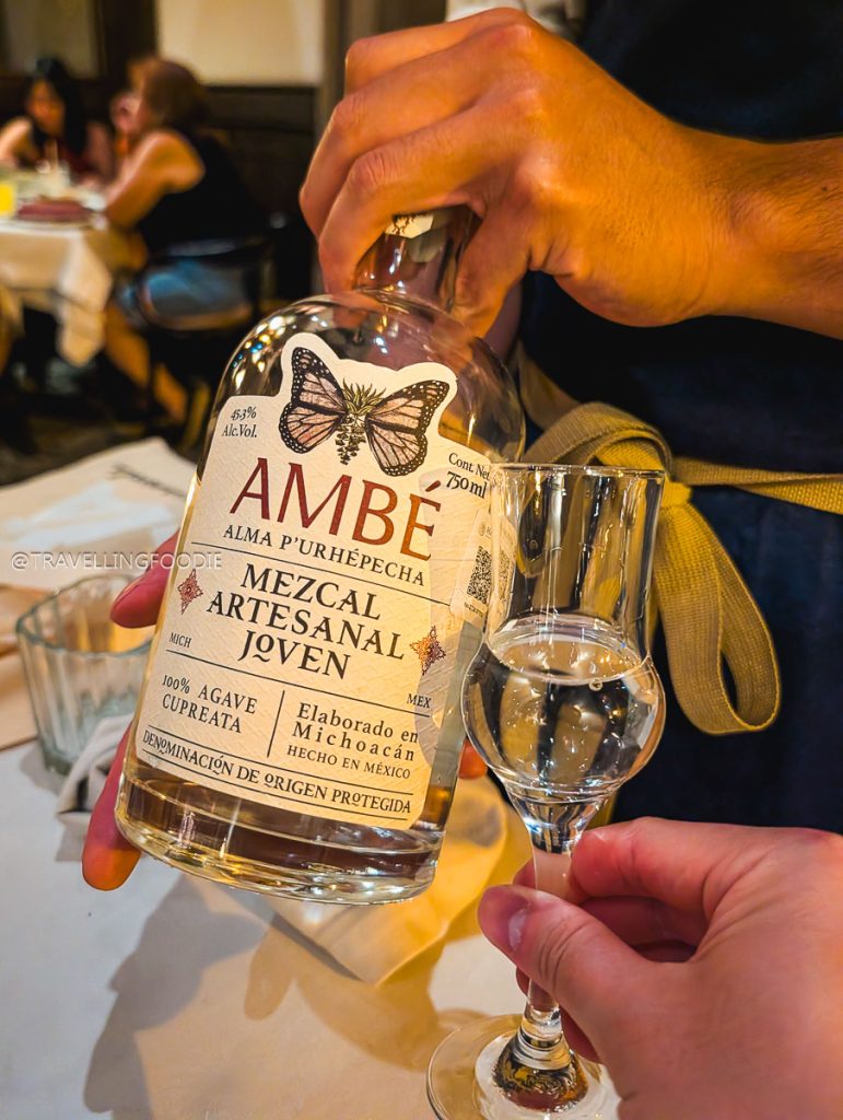 Pouring artisanal Michoacan Mezcal for a tasting, a must-do activity on your Michoacan road trip.