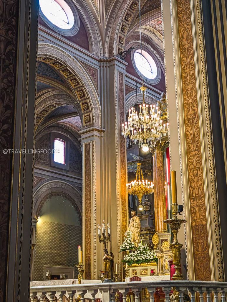 Beautiful golden altar and crystal chandeliers inside the historic Morelia Cathedral.