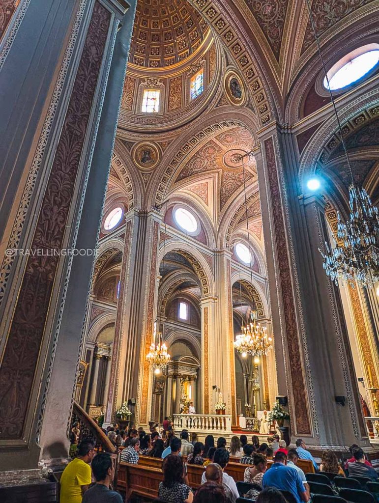 The stunning vaulted ceilings and chandeliers inside Morelia Cathedral on our Mexico vacation.
