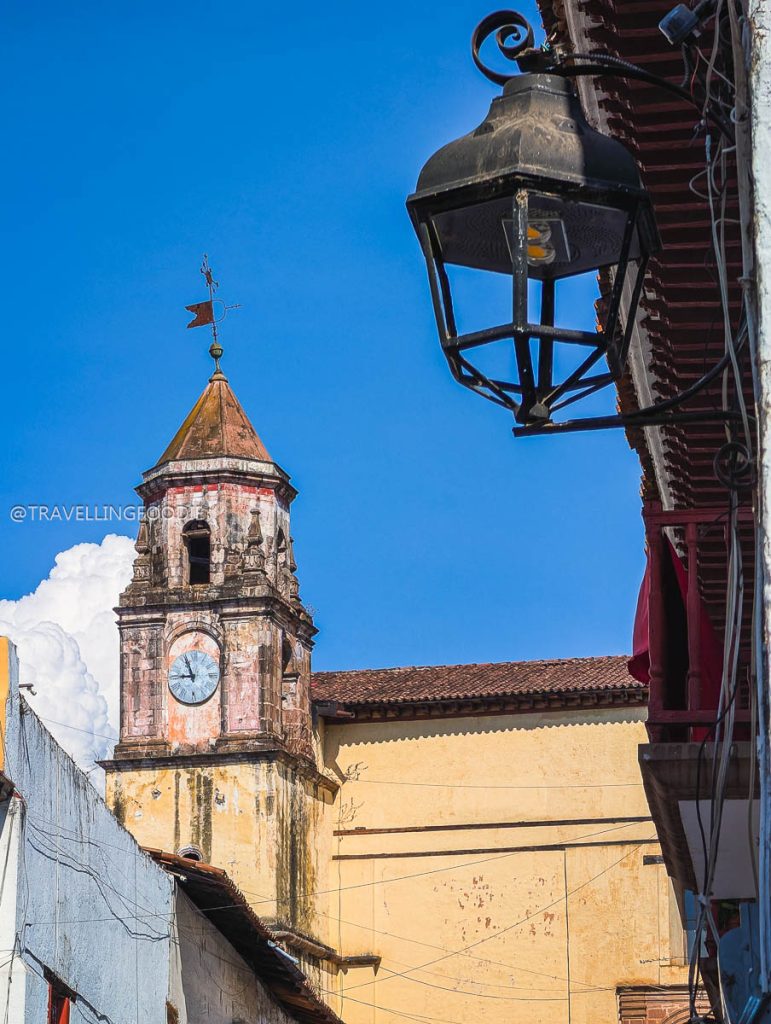 Vintage street lamp and colonial church tower in Patzcuaro, highlighting beautiful things to do in Michoacan.