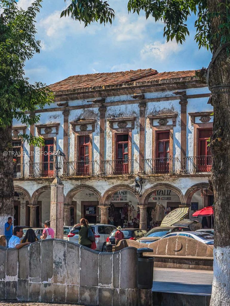 Historic whitewashed buildings with balconies in Patzcuaro during an unforgettable Mexico vacation.