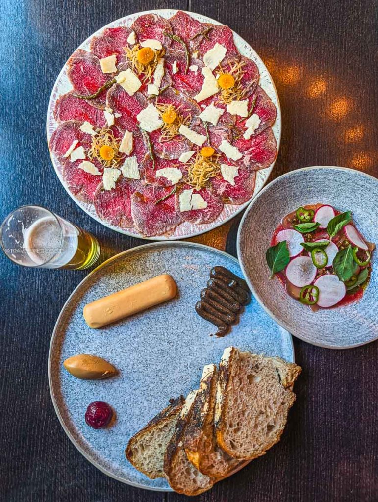 Bison carpaccio, tuna crudo, and sourdough appetizers at Bar Lupulus in Ottawa.